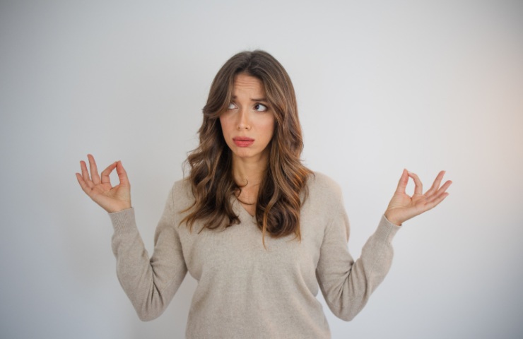donna che fa una posizione yoga con le mani